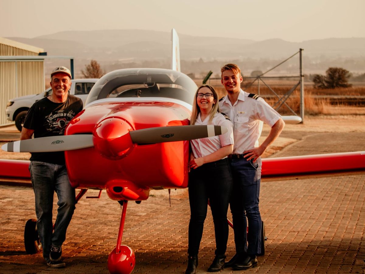 Newly qualified pilots with their instructor
